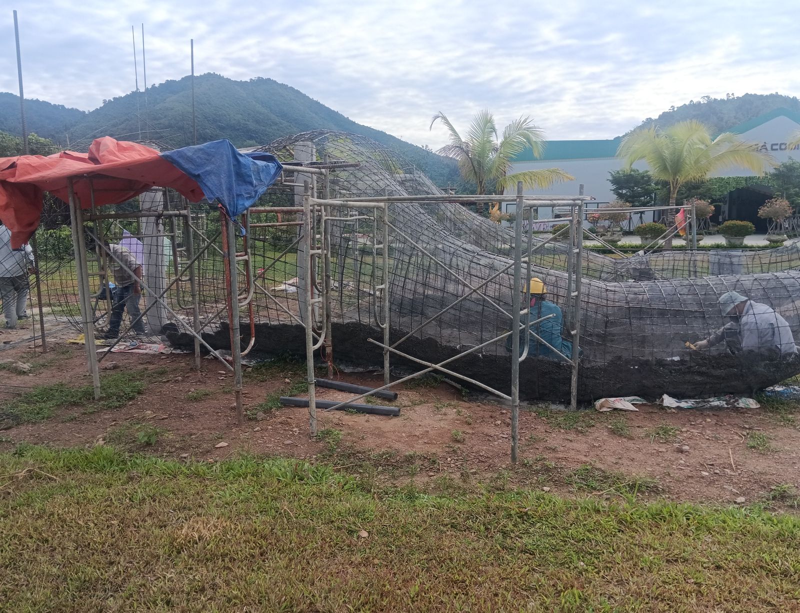 Thợ điêu khắc đắp lớp vữa xi măng đầu tiên lên khung lưới thép tạo khối thô cho tượng
